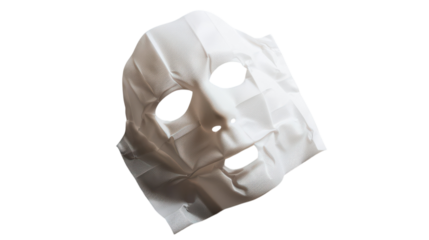 A textured white mask placed on a smooth surface, resembling a human face, showcasing intricate details in the fabric on transparent background