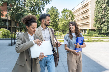 Group of modern successful business people innovative technology experts standing out of office building, discussing ideas and innovations. Leaders in global marketing strategy professional occupation