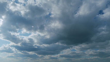 Obraz premium Stratus with stratocumulus clouds flying slowly on beautiful blue sky horizon background. Timelapse.
