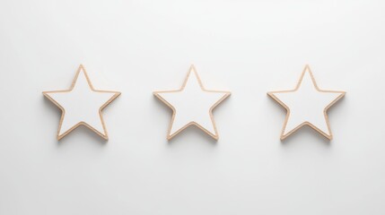 Fototapeta premium Three wooden star shapes are arranged in a row against a clean, white background, creating a minimalist and elegant aesthetic.