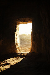 Bright light streaming through a rocky cave entrance