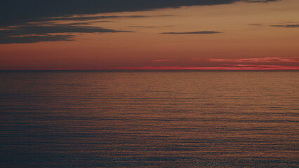 Fototapeta premium Water Ripple Background Texture. Sunlight Reflect On Water Surface. Orange Sea At Sunset.