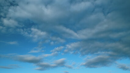 Fototapeta premium Cloud cumulus and cirrocumulus on different layers nature with skyscrapers. Nice weather and environment concept.