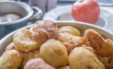 Bowl of freshly fried dough snacks, golden and crispy, perfect for breakfast or snack time.	
