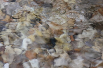 water flowing over river rocks