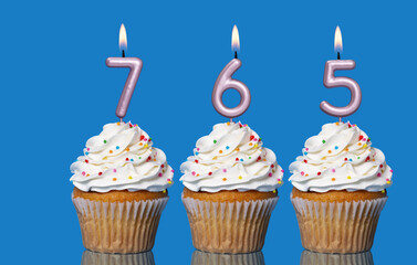 Birthday Cupcakes With Candles Lit Forming The Number 765