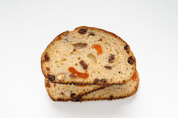 whole grain bread with nuts and dried fruits on a white background