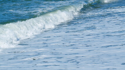 Beach Is Covered With Pebble. Small Sea Waves. Waves Crashing On A Beach. Slow motion.