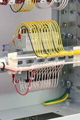 The reverse side of the electrical switchboard. The connected wires are tied with plastic ties.