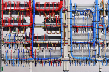 The reverse side of the electrical switchboard. The connected wires are tied with plastic ties.