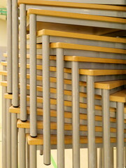 Stackable tables in a sports hall, perfect for exams and events. Space-saving, flexible, and easy...