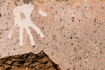 Hand print on cracked and polished stone