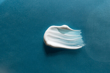 Fototapeta premium A smear of cream on a light background. Beauty concept.