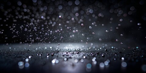 Raindrops dancing on a dark surface create a mesmerizing decorative impressionist effect