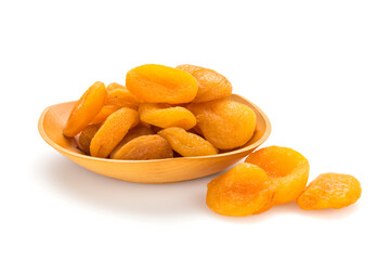 Dried apricots  in and out of bowl on white background