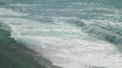 Calm Sea Surface. Blurred Soft Foamy Waves Washing Sand Beach. Slow motion.