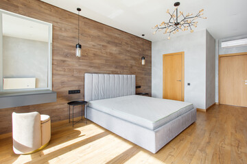 large modern bedroom bed with headboard warm wooden laminate on wall