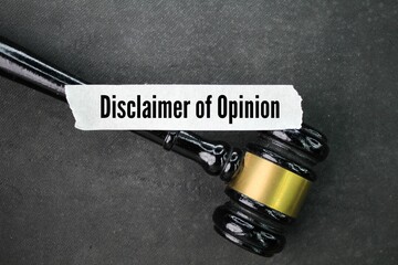 judge's hammer and a sticker with the words disclaimer of opinion. concepts do not agree