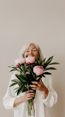 An elderly woman holds a beautifully bouquet with peonies. Pastel palette. Happy Mother's Day or Happy Women's day, birthday. Space for text © bosotochka