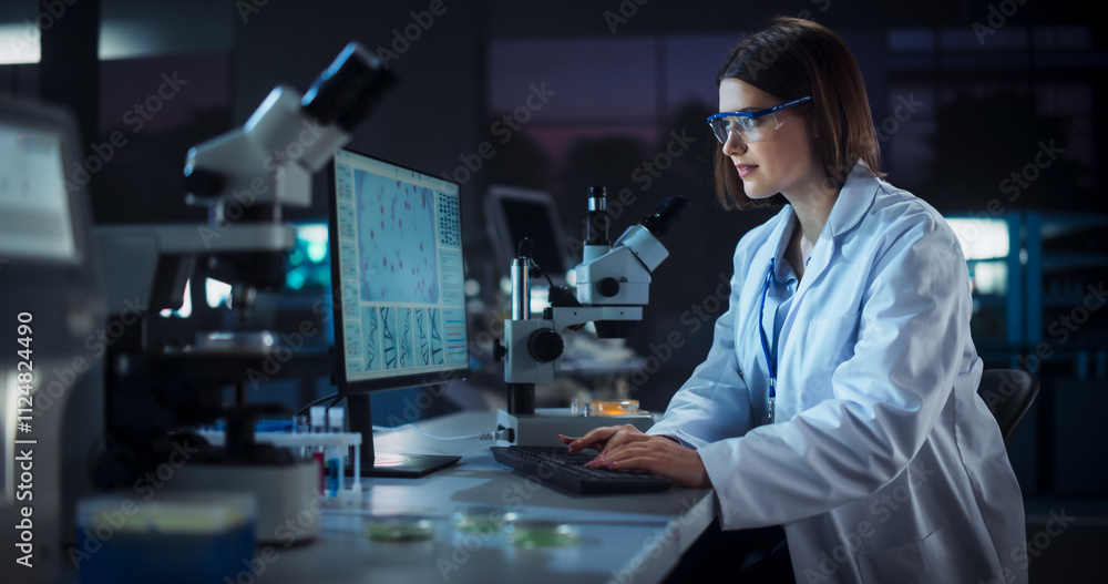 Leinwandbilder caucasian female scientist working on a computer in the evening. specialist using a gene sequencing 