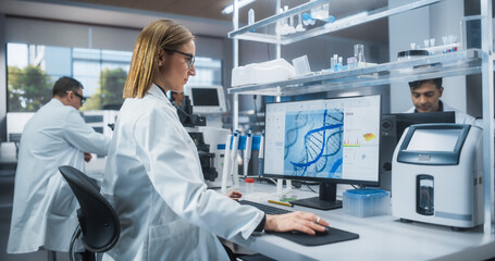 Caucasian Female Scientist Working on a Desktop Computer, Analyzing DNA Samples. Specialist Using a Gene Sequencing Software. Advanced Biotechnology Lab in a Medical Research and Development Center