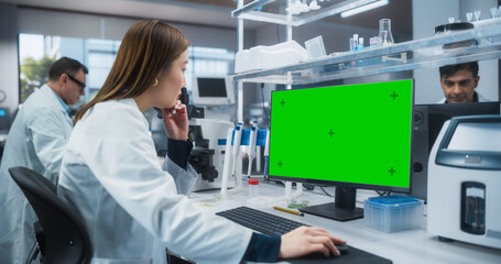 Medical Research and Development Laboratory: Beautiful Asian Female Scientist Working on a Computer with a Green Screen Chroma Key Template. Modern Genetic Engineering Lab