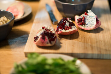 Preparing Fresh Pomegranate Seeds in a Cozy Kitchen — A Symbol of Healthy Cooking, Natural Ingredients, and Vibrant Flavors