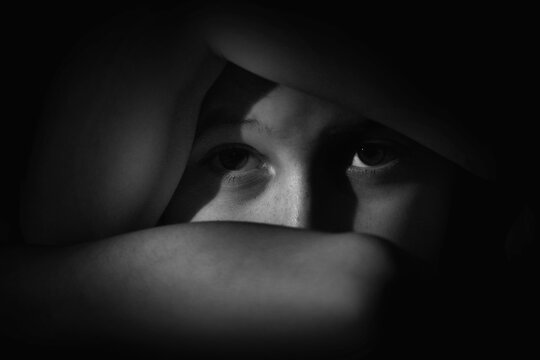 Crown of thorns and rosary beads on brown texture background with space for text