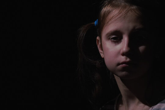 Crown of thorns and rosary beads on brown texture background with space for text