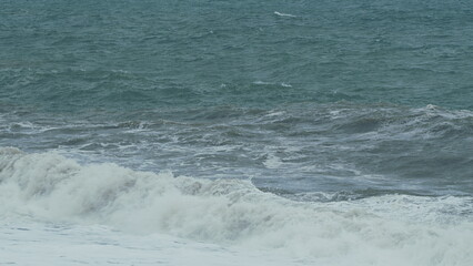 Big Wave Splashing. Waves With Texture And Wind Spray. Powerful Tsunami Wave. White Foam On Wind.