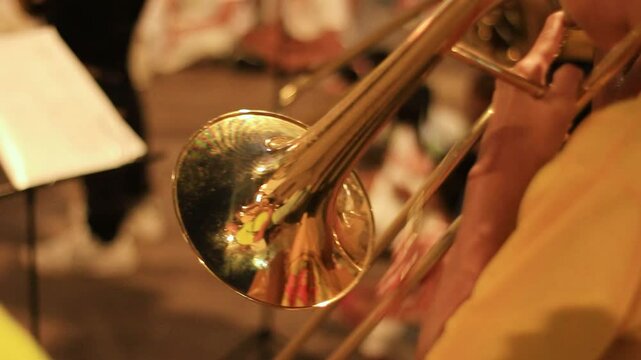 close up of a man playing trombone wind instrument