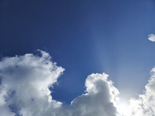White fluffy cumulus clouds in the summer sky