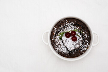 An Elegant Chocolate Dessert Beautifully Served in a White Bowl with a Garnish on Top on white...