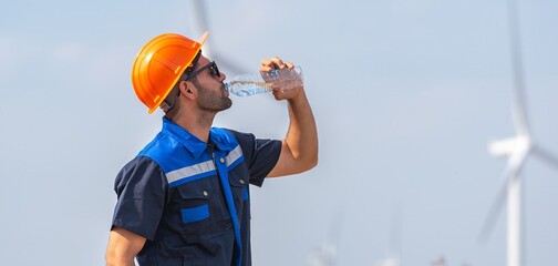 engineer Man in a blue and orange shirt is drinking water