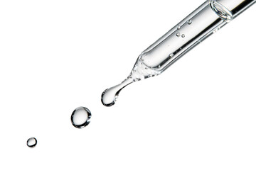 Close up clear dropper releasing liquid drops with reflections isolated on background.