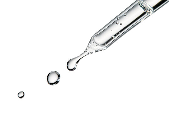 Close up clear dropper releasing liquid drops with reflections isolated on background.
