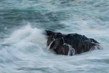 Waves breaking over coastal rock