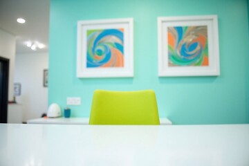Office space white desk lime-green chair abstract art pieces