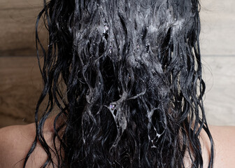 Shampooing dark curly hair in shower