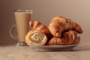 Freshly baked croissants and coffee with cream.