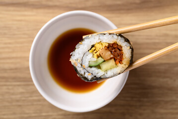 Gimbap or kimbap, Korean food made from cooked rice with vegetables, meat, egg and wrapped with dried seaweed dipping with sauce