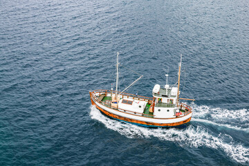 Ship fishing boat near Hamnoy fishing village in Lofoten Islands, Norway, Europe