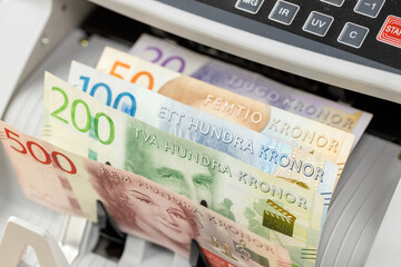 Sweden money. Money counting machine with Swedish kronor. Business concept. Financial operations,...