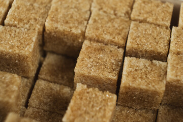 Macro cubes of brown cane unrefined demerara sugar.