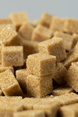 Macro cubes of brown cane unrefined demerara sugar.