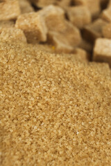 Brown cane unrefined demerara sugar in the form of crystals and cubes