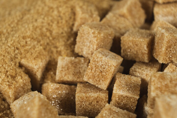 Brown cane unrefined demerara sugar in the form of crystals and cubes