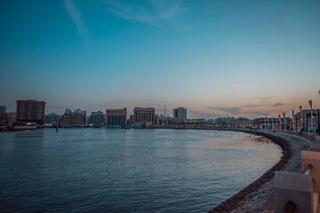 Fototapeta premium Waterfront Cityscape: A calm city waterfront scene, with a view of modern architecture and a serene water body in the foreground