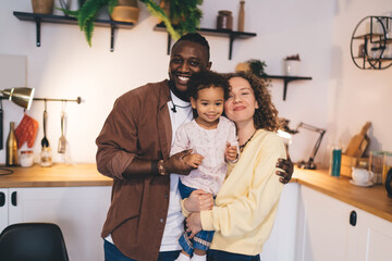 Authentic family bonds demonstrated through interlinked connection and sharing intimate moment at...