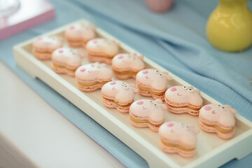 macaroons in the form of a pig on a glass plate.